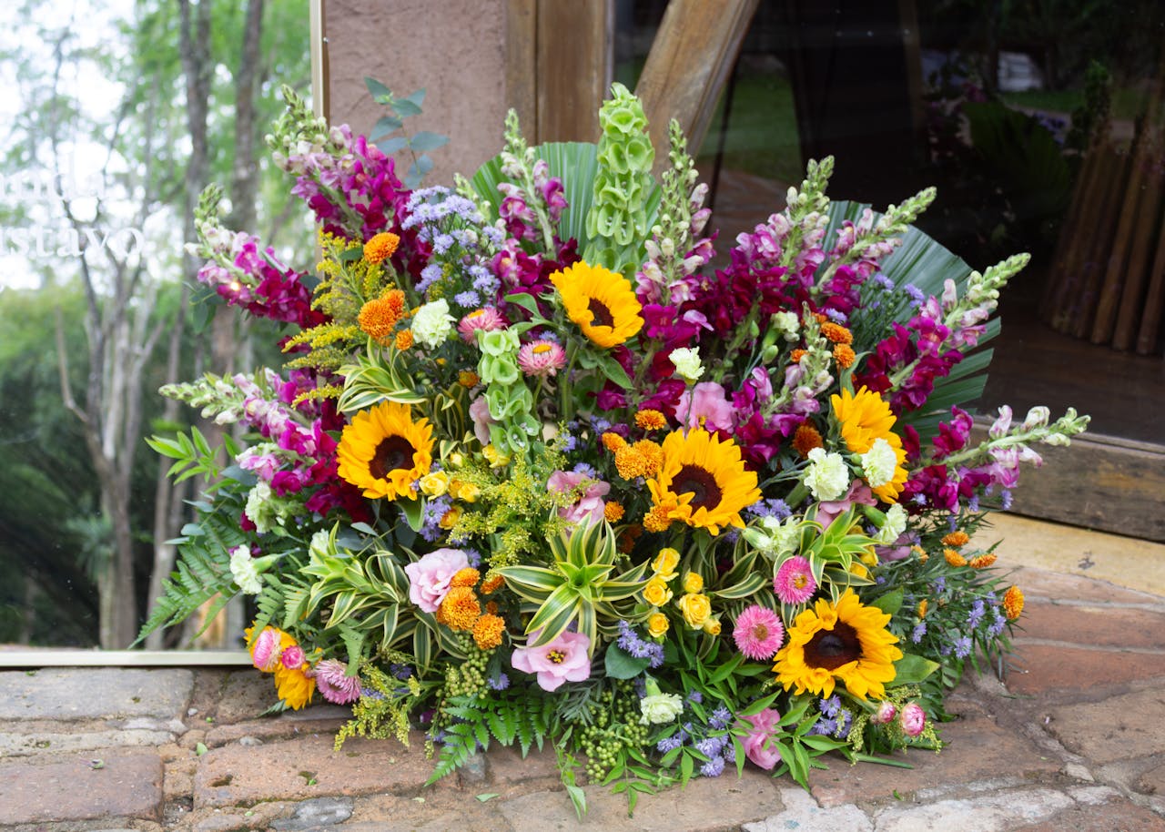 Colorful floral arrangement featuring sunflowers and diverse blooms displayed outdoors in São Paulo.